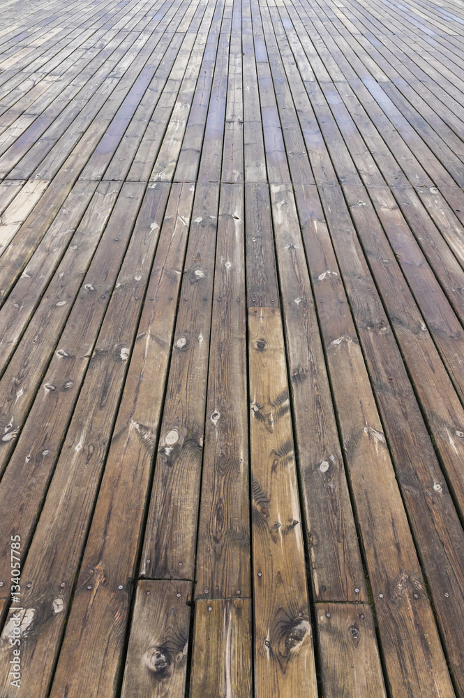 Old wooden brown background texture with perspective. Wooden planks that make up a large pier Old wooden brown background texture with perspective. Wooden planks that make up a large pier