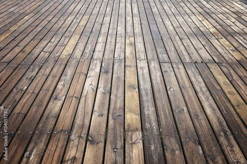Old wooden brown background texture with perspective. Wooden planks that make up a large pier