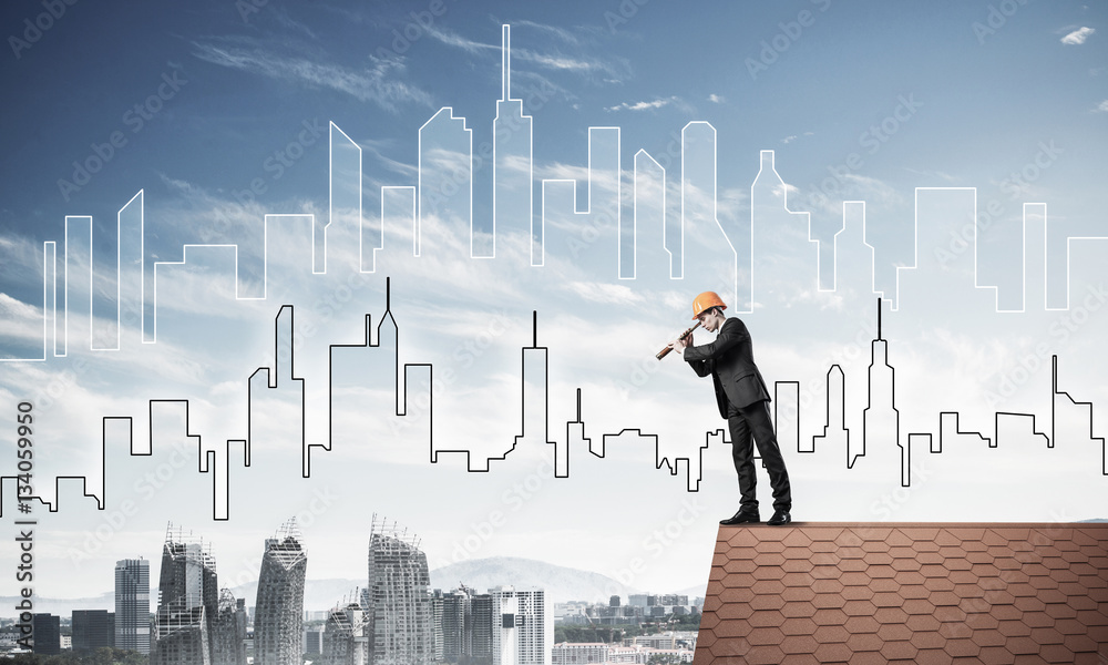 Engineer man standing on roof and looking in spyglass. Mixed med Engineer man standing on roof and looking in spyglass. Mixed med