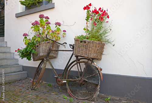 Reused bycycle with baskets of flowers