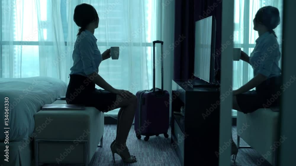 Young businesswoman drinking coffee and admire view from window in hotel room
Young businesswoman drinking coffee and admire view from window in hotel room