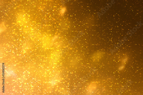 Golden abstract sparkles or glitter lights. Festive gold background.defocused circles bokeh or particles. Valentines day template