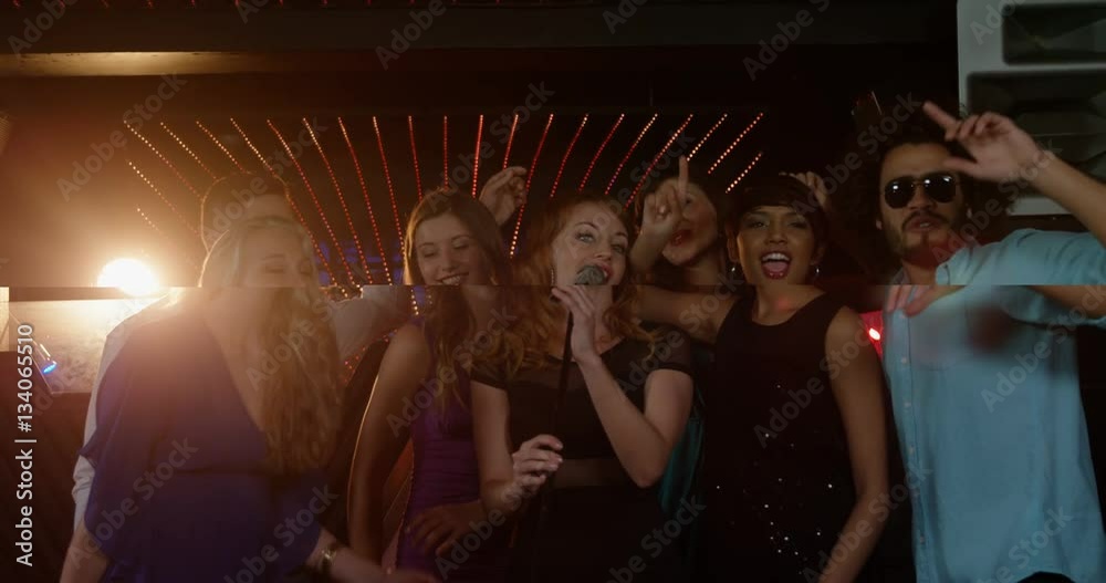 Happy friends singing songs together in bar Happy friends singing songs together in bar