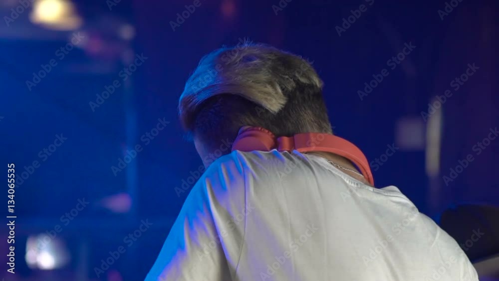Male dj dancing and playing records with disco style background Male dj dancing and playing records with disco style background