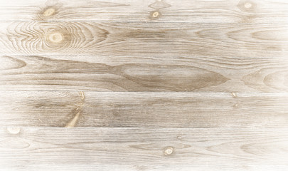 Old weathered wood surface with long boards lined up. Wooden planks on a wall with grain and texture. Light neutral tones with age.