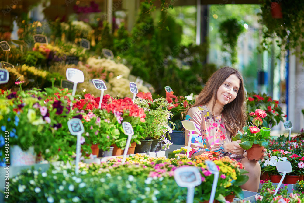 Woman selecting flowers on Parisian flower market or in shop