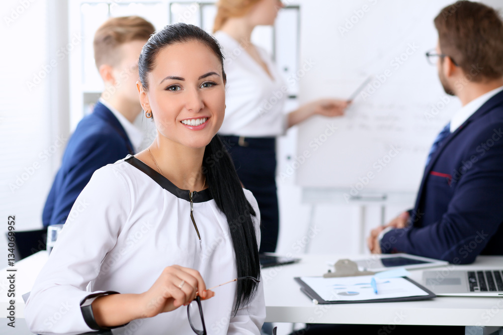 Business people at a meeting in the office. Focus on boss woman Business people at a meeting in the office. Focus on boss woman