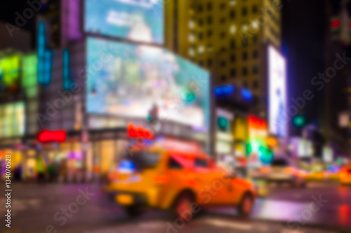 New York City night street scene defocused blur with lights and taxi.  © littleny