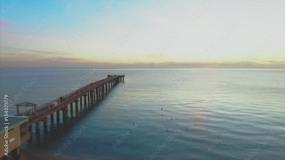 Aerial of beach and pier during sunrise Aerial of beach and pier during sunrise
