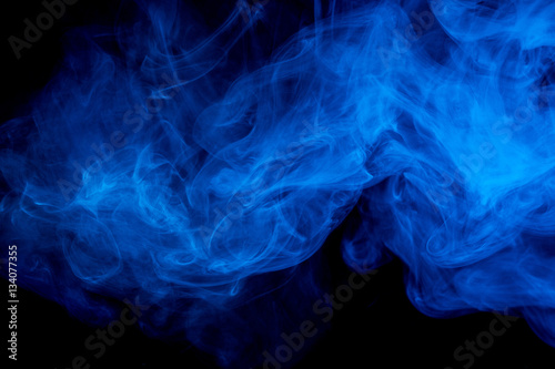Abstract smoke Weipa. Personal vaporizers fragrant steam. The concept of alternative non-nicotine smoking. Blue smoke on a black background. E-cigarette. Evaporator. Taking Close-up. Vaping. © Vagengeim
