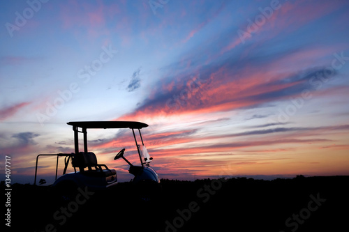 silhouette golf cart in golf course withcolorful twilight sky soft cloud for background backdrop use