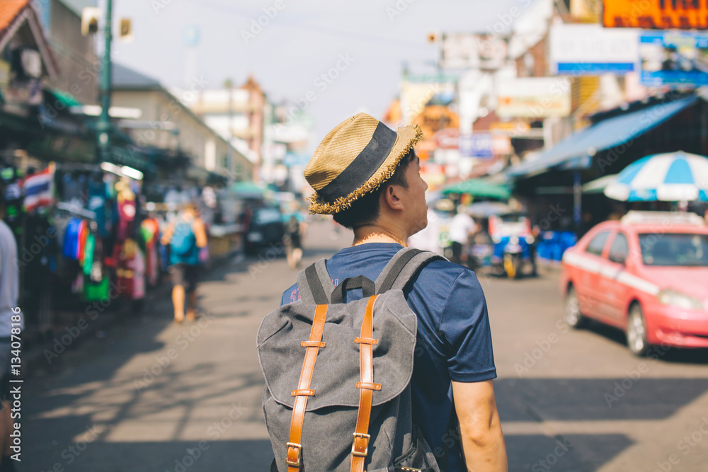 Young Asian traveling backpacker in Khaosan Road outdoor market Young Asian traveling backpacker in Khaosan Road outdoor market