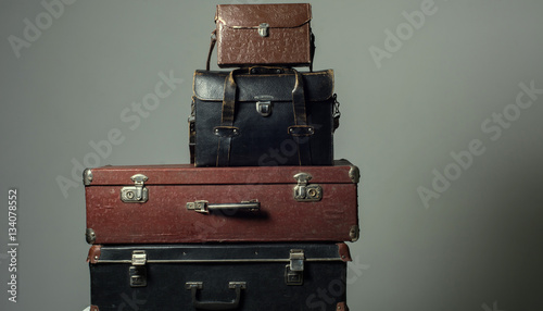 Background stack of old shabby suitcases form a tower © kanzefar