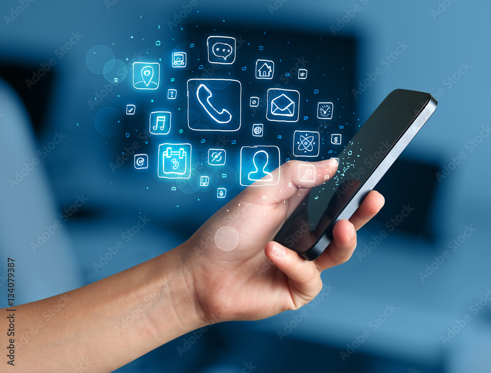 Hand holding smartphone with mobile app icons Hand holding smartphone with mobile app icons