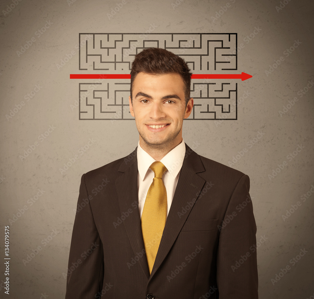 Handsome business guy solving maze Handsome business guy solving maze