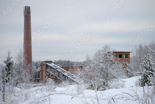 Ruins of an abandoned pulp and paper plant in the village of Harlu winter day. Karelia photo