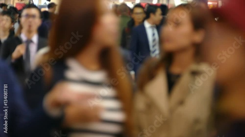 Urban life- out of focus of Crowd people walk on street side to train station, subway at Shibuya Tokyo Japan. Blur and slow motion video 4K of tourist, traveler at downtown, business area, city center photo