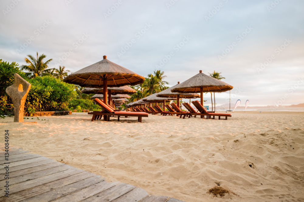Fototapeta premium Relaxation at the beach in a wooden armchair