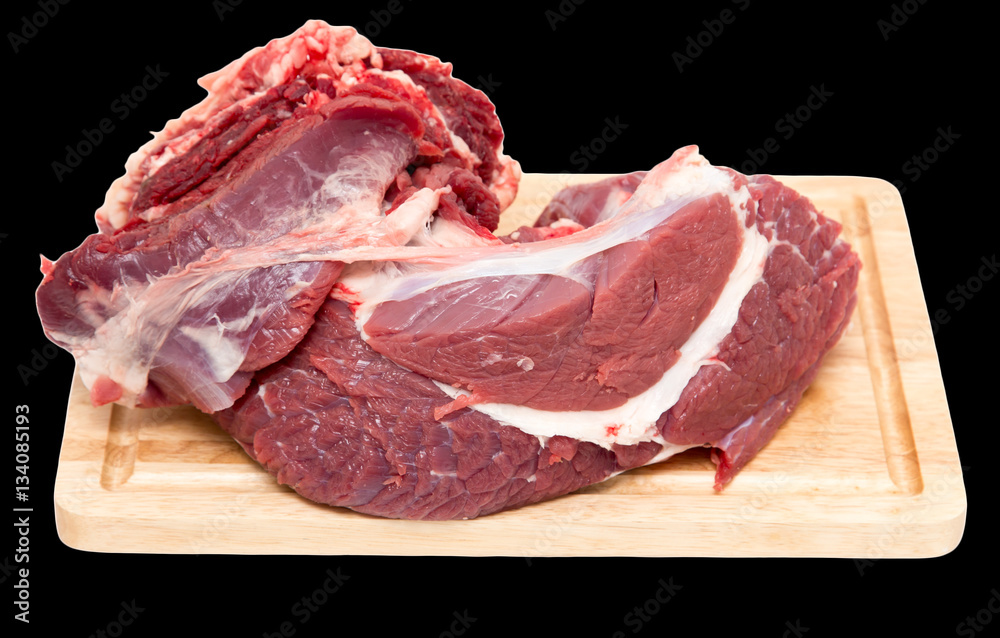meat on the board on a black background