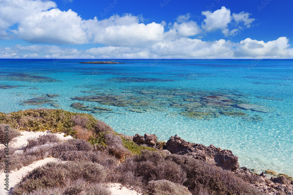Great beach Elafonisi. Greece, Crete. Fine white sand and blue sky with clouds. Clear blue water. Shallow water. Seascape. Great beach Elafonisi. Greece, Crete. Fine white sand and blue sky with clouds. Clear blue water. Shallow water. Seascape.
