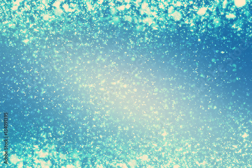 Abstract round silver bokeh or glitter lights on blue background. Circles defocused particles