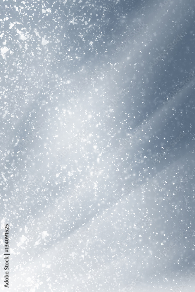 Obraz premium Snowflakes particles and white bokeh or glitter lights on silver background. Christmas abstract template