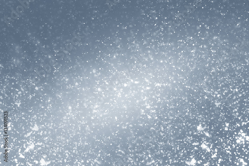 Snowflakes particles and white bokeh or glitter lights on silver background. Christmas abstract template