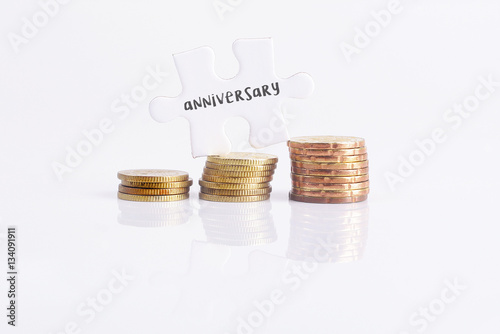 White missing puzzle and gold coins with anniversary,copyspace