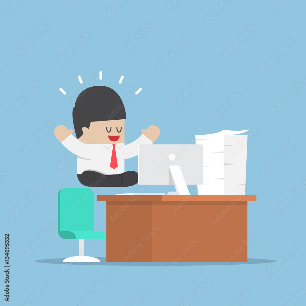 Businessman meditating in lotus position over his desk Businessman meditating in lotus position over his desk