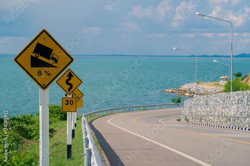Road and traffic sign with sea background