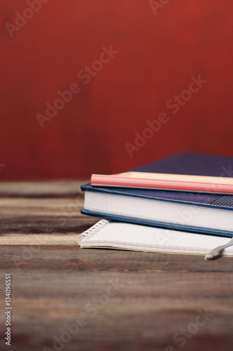 a stack of notebooks on the table