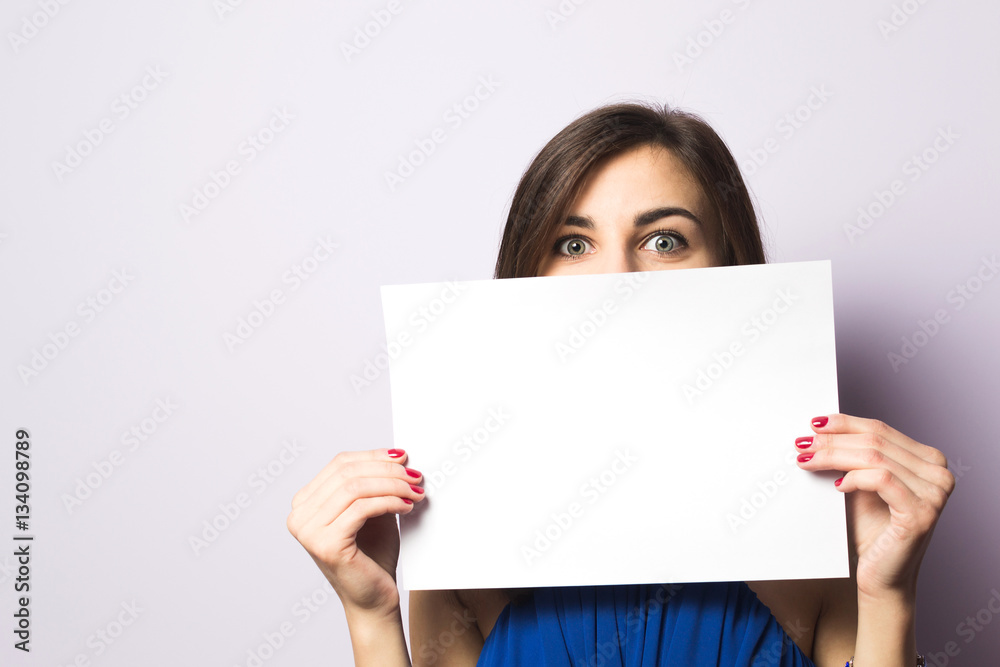 Portrait of a beautiful girl with a sheet of paper in his hands Portrait of a beautiful girl with a sheet of paper in his hands