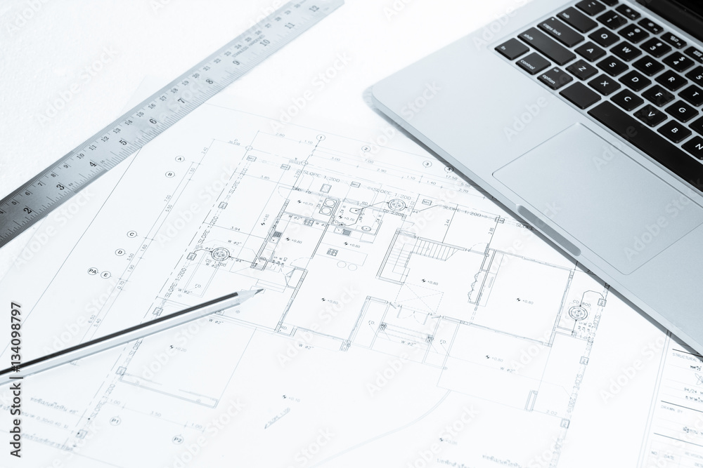 Pen, metal ruler, and notebook over house construction blueprint Pen, metal ruler, and notebook over house construction blueprint