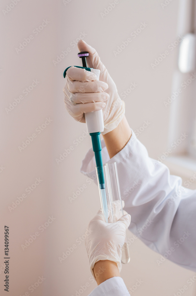Scientist working with chemicals in the lab at the university. Scientist working with chemicals in the lab at the university.