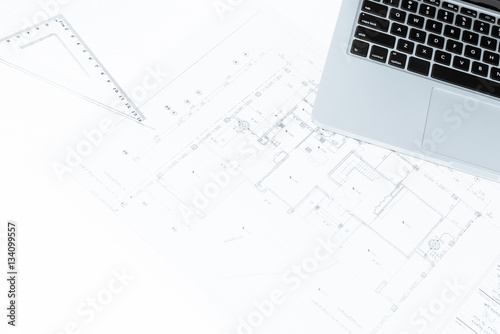 drawing rulers, and notebook over house construction blueprint w