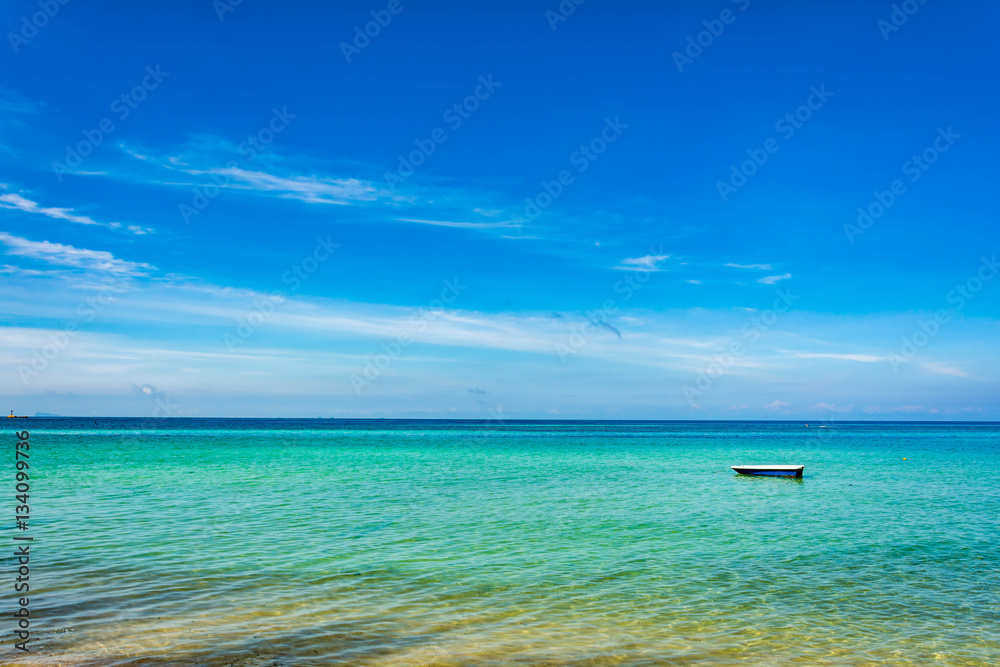 Fototapeta premium Boat on Blue sea and a moving reflection