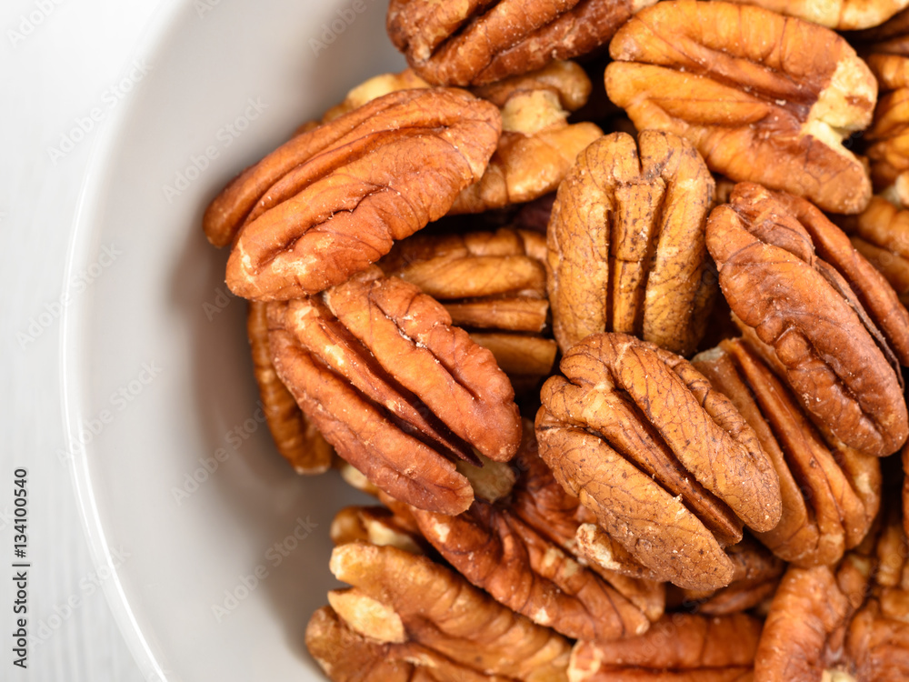 Pecan Nuts In White Bowl On Table Pecan Nuts In White Bowl On Table