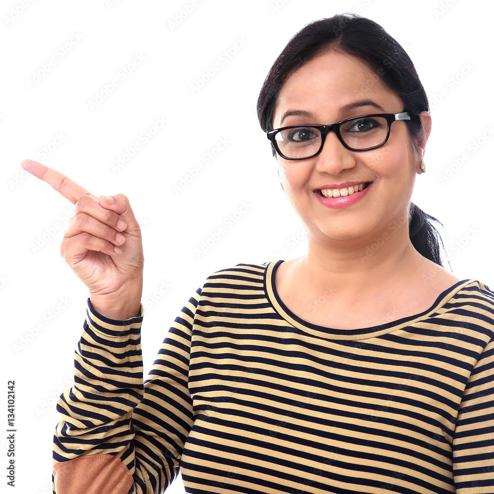 Happy woman pointing at copy space against white background Happy woman pointing at copy space against white background