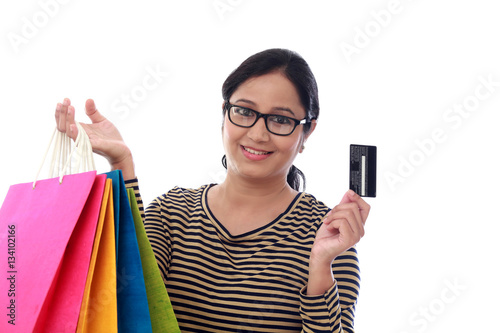 Happy young woman with shopping cards and debit card-Cashless pu