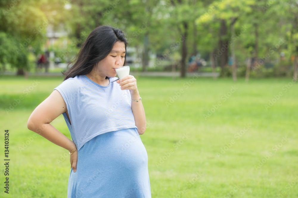 Pregnant woman drinking organic milk with a copy space. Pregnant woman drinking organic milk with a copy space.