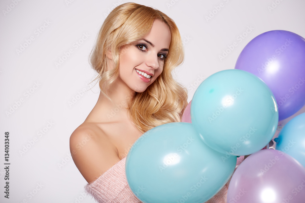 Young beautiful blonde girl holding balloons Young beautiful blonde girl holding balloons