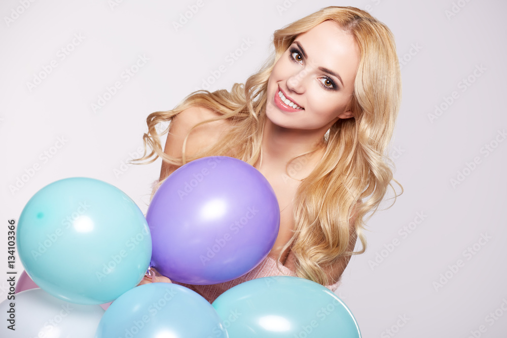 Young beautiful blonde girl holding balloons Young beautiful blonde girl holding balloons