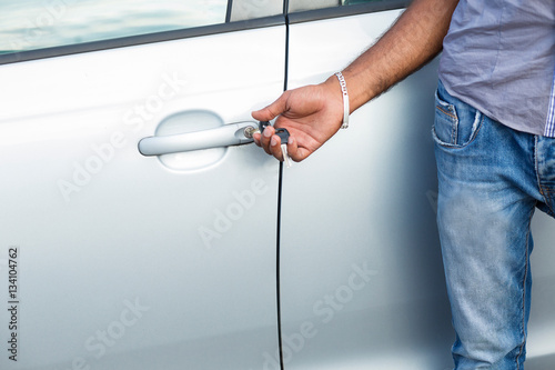 man unlocks car door alarm systems with remote control. Vehicle convenience safety security system