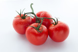 Four big red tomato on a white background