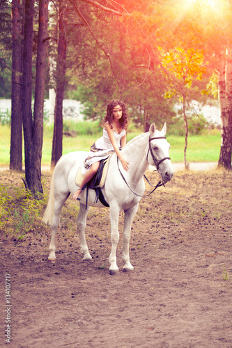 Young woman on a horse. Horseback rider, woman riding horse © Miramiska