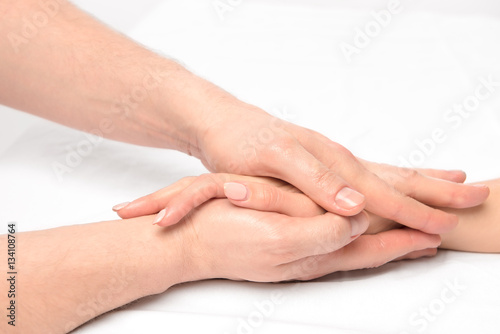 hand massage in the salon of a physiotherapist on a white backgr