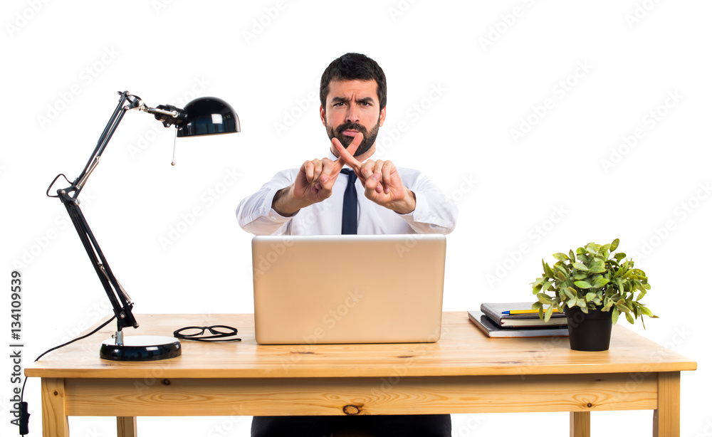 Businessman in his office doing NO gesture Businessman in his office doing NO gesture