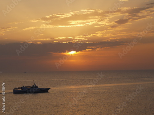 sailing boat on sea during sunset