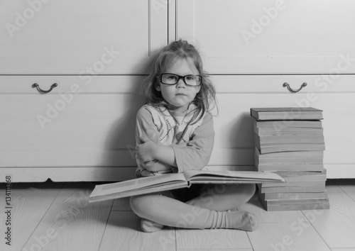 close up girl child with a book,black white.