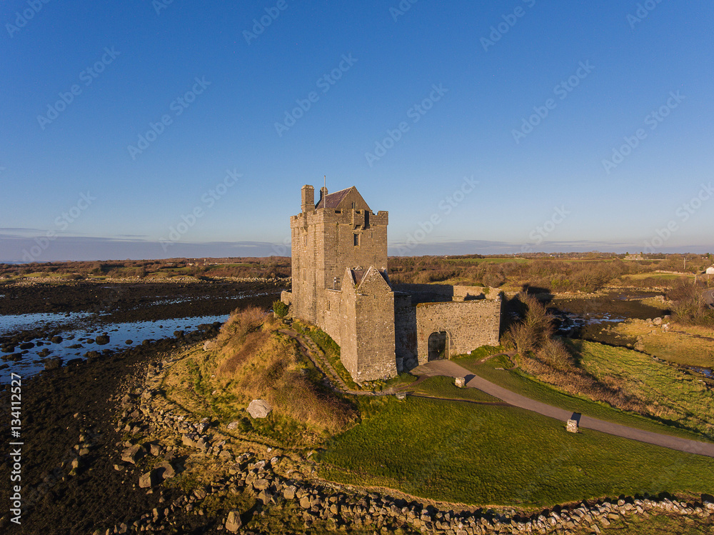 Aerial Dunguaire Castle Evening Sunset, near Kinvarra in County Galway, Ireland - Wild Atlantic Way Route. Famous public tourist attraction in Ireland.